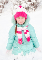 Portrait of smiling little girl in winter day