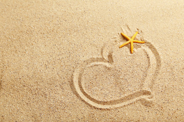 Heart handwritten on a beach sand