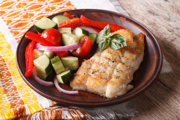 Grilled white fish with fresh vegetables close-up. horizontal  