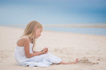 Fototapeta na wymiar Beautiful young girl on the beach