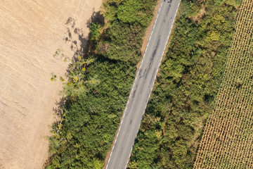 aerial view of village road and harvest fields