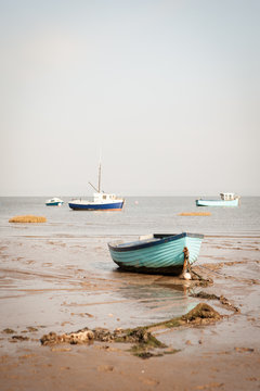 Morecambe Bay fishing boats. Traditional fishing boats resting on the low tide sands of Morecambe Bay on the Lancashire coast in North West England.