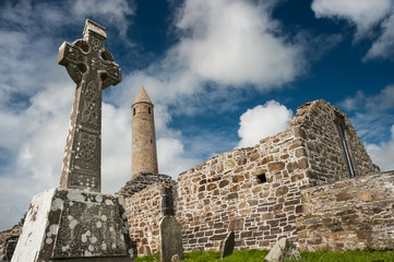 church ruins and medieval round tower in county Kerry