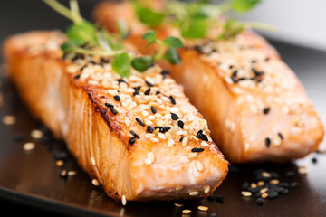 Grilled salmon on black plate