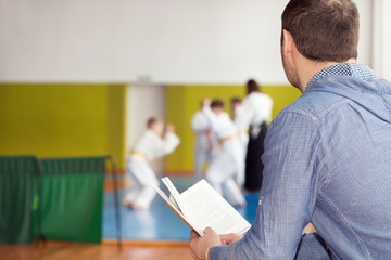 Father waiting for his kids training martial arts