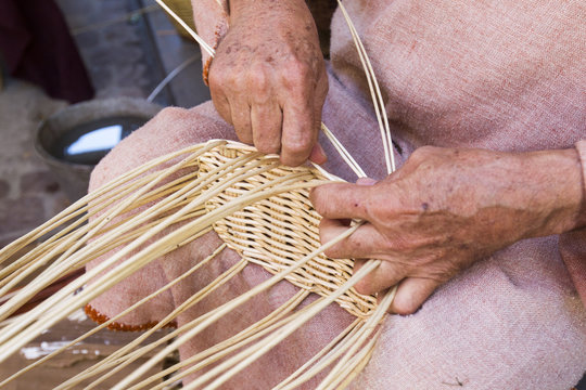 craftsman making wicker baskets traditionally