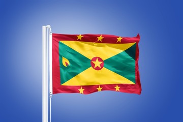 Flag of Grenada flying against a blue sky