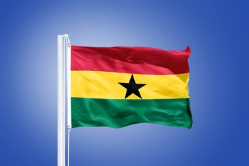 Flag of Ghana flying against a blue sky
