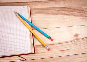 notepad with a pencil on a wooden background
