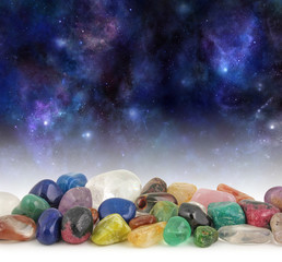 Cosmic Healing Crystals - Deep space background with stars, suns and planets with a selection of...