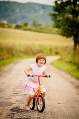 Fototapeta na wymiar Child on firs bike