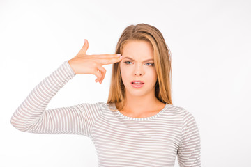 Fototapeta premium tired girl imitates gun at her temple