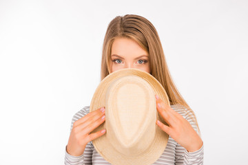 beautiful shy girl hiding her face behind her hat