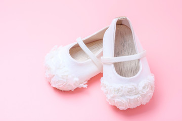 cute baby shoes for kids on pink background.