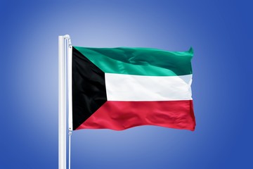 Flag of Kuwait flying against a blue sky