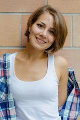 young beautiful woman in cell shirt smiling