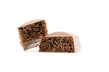 two slices of porous chocolate close-up texture isolated on a white background
