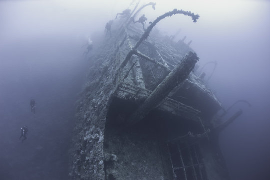 Divers on a deep underwater shipwreck