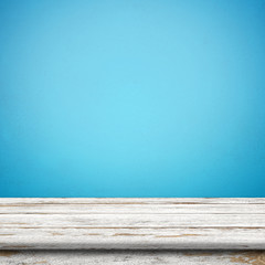 Vintage wood table in blue wall room.