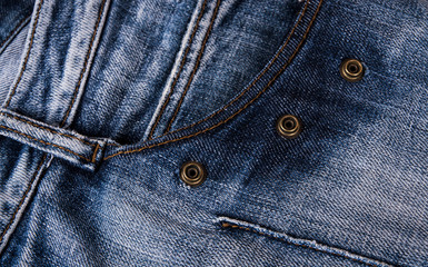 fashionable clothes. pile of jeans on a wooden background