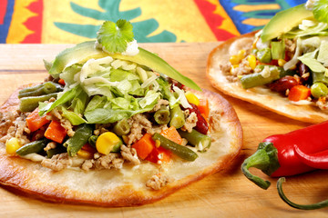 Tostadas with ground beef and vegetables on wooden background