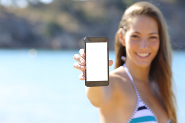 Sunbather showing blank phone screen on the beach