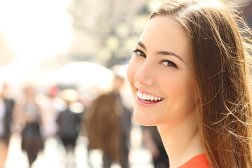 Woman face smile with perfect teeth looking you