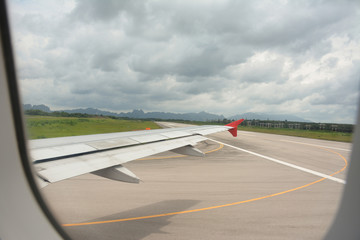 Wing view and taxi way before takeoff On cloudy days