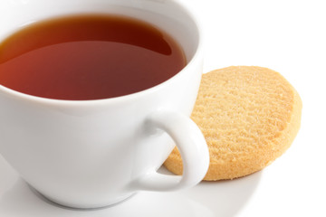 Detail of a white ceramic cup of rooibos tea with shortbread bis