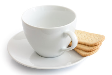 Empty white ceramic cup and saucer with finger tea biscuits. Iso