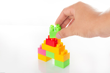 Colorful Toy Blocks with hand Isolated on White Background.