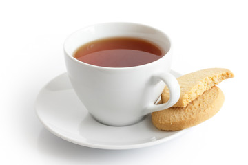 White ceramic cup and saucer with tea and shortbread biscuits. I