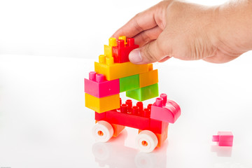 Colorful Toy Blocks with hand Isolated on White Background.
