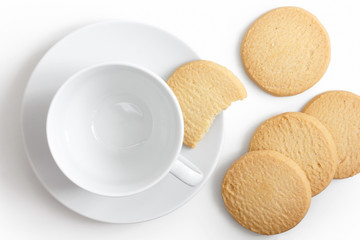 Obraz na płótnie Canvas Empty white cup and saucer with shortbread biscuits from above.