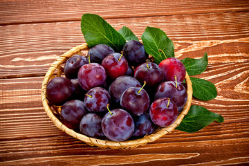 fresh plums on a wooden table