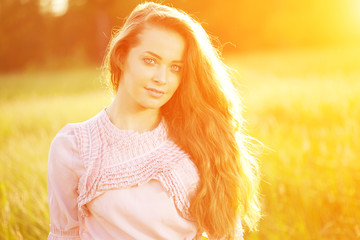 Young hipster model woman Casual Girl in field in Sunset in spri
