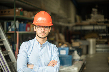  a young man with a helmet on his head on an industrial site