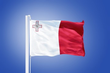 Fototapeta na wymiar Flag of Malta flying against a blue sky