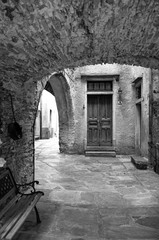 Fototapeta na wymiar Vogogna (Ossola Valley, Piedmont): old alley. Black and white photo
