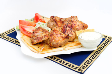 Souvlaki, kebab, grilled meat on pita bread with sauce, tomatoes