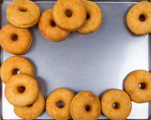 fried equal round doughnuts in frame