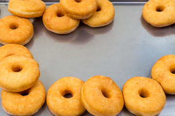 fried equal round doughnuts in frame