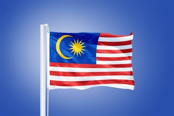 Flag of Malaysia flying against a blue sky