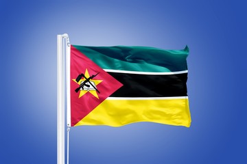 Flag of Mozambique flying against a blue sky