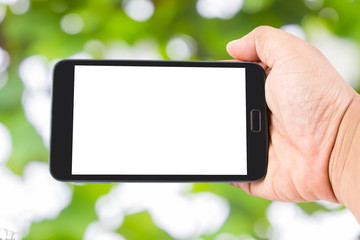 Man hand hold blank touch screen smart phone on Soft green natur