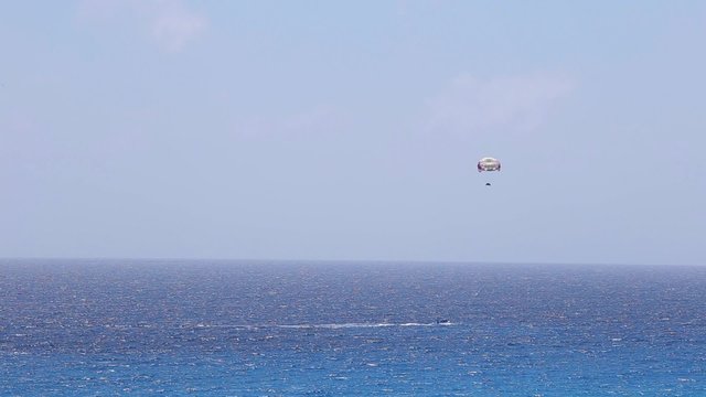 Parasailing From Boat in caribbean sea at Cancun
