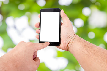 Man hand hold blank touch screen smart phone on Soft green natur