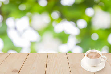 Coffee cup on wood texture and Green bokeh background