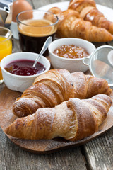delicious breakfast with fresh croissants, vertical