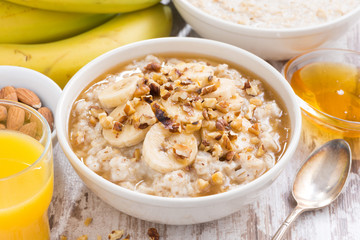 healthy breakfast - oatmeal with banana, honey and walnuts